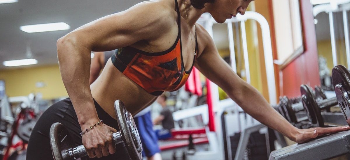 woman seriously performing gym exercise